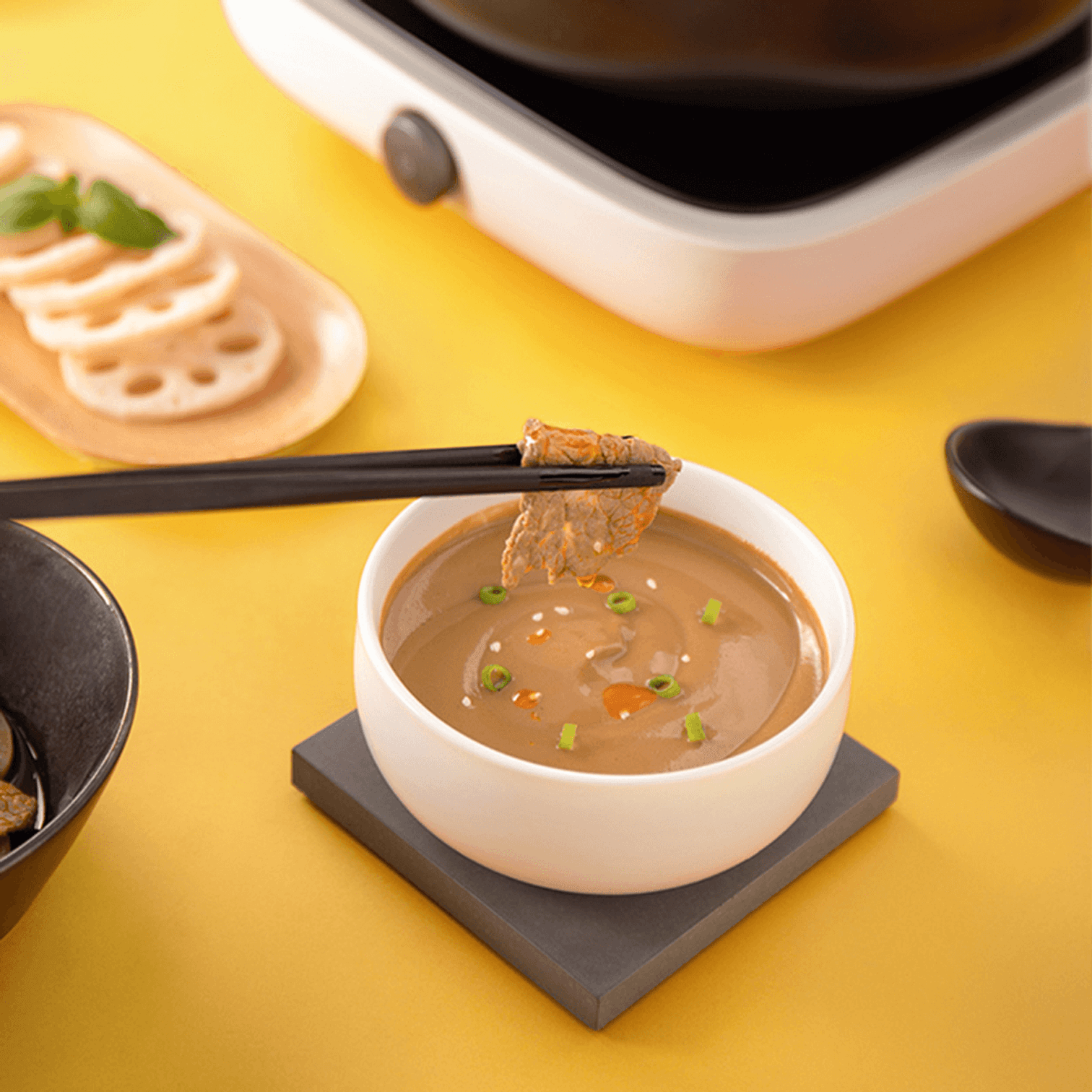 HAIDILAO Original Hot Pot Dipping Sauce with scallion and sesame, chopsticks dipping grilled meat into the sauce