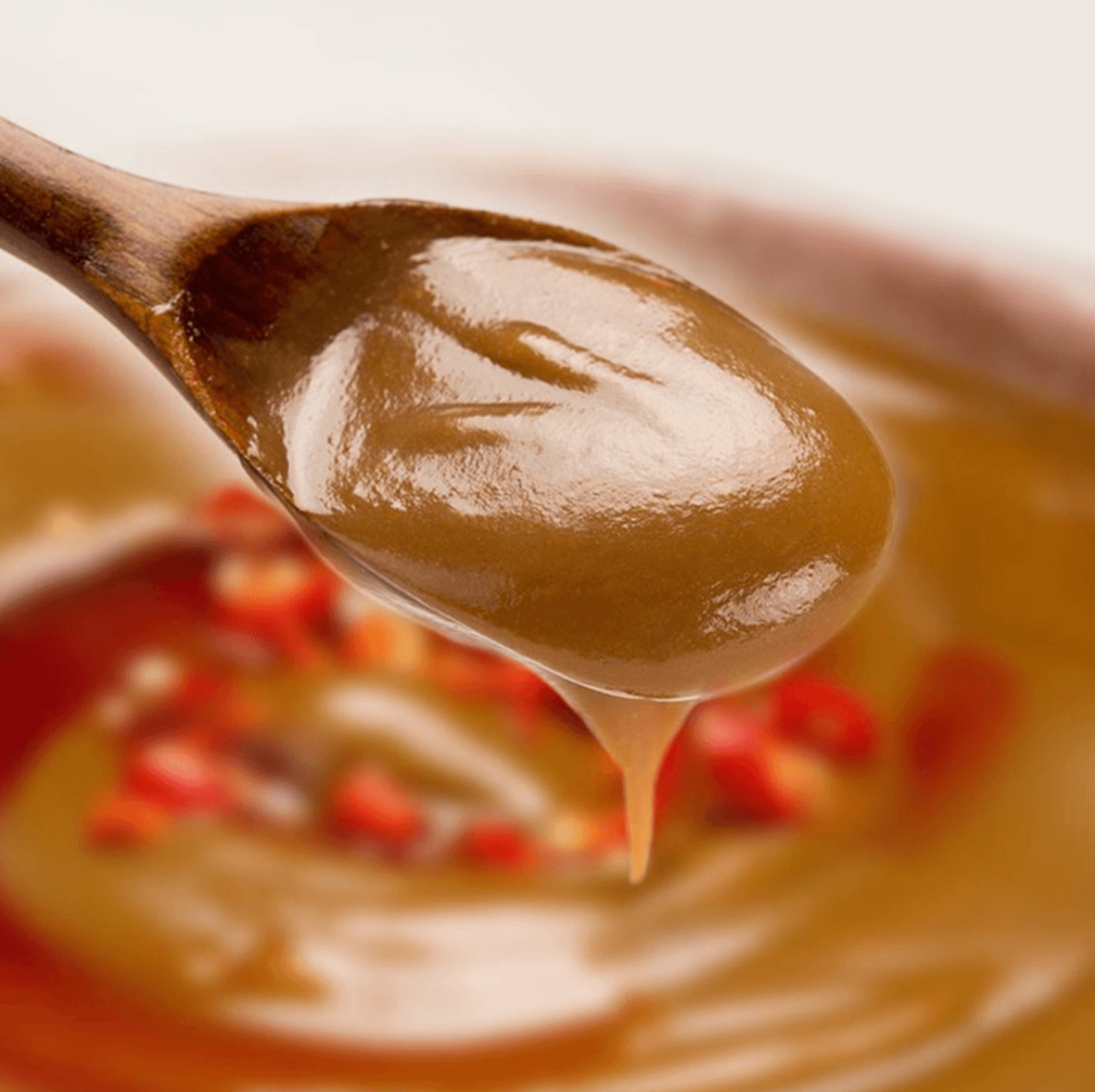 Spoonful of HAIDILAO Spicy Mala Flavor Hot Pot Dipping Sauce with peanut and sesame