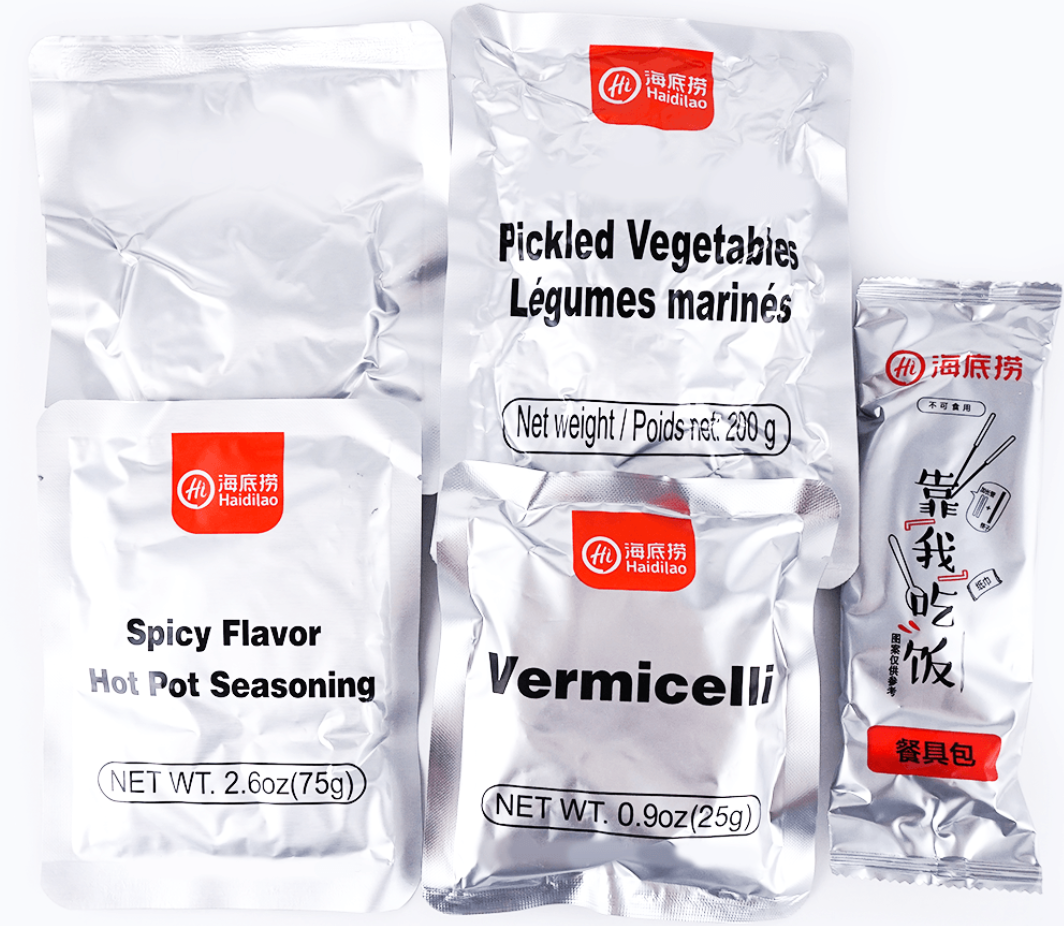HAIDILAO Spicy Flavor Self-Heating Hot Pot contents: pickled vegetables, spicy flavor seasoning packet, vermicelli, and utensil packet