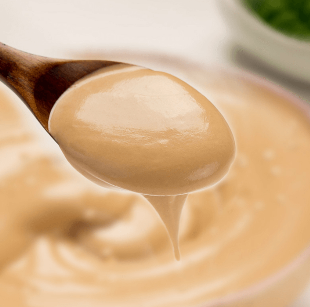 Spoonful of HAIDILAO Original Flavor Hot Pot Dipping Sauce, creamy peanut and sesame sauce