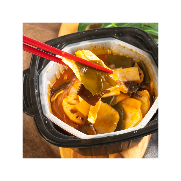 Chopsticks lifting tofu skin from HAIDILAO Self-Heating Hot Pot with Vegetables