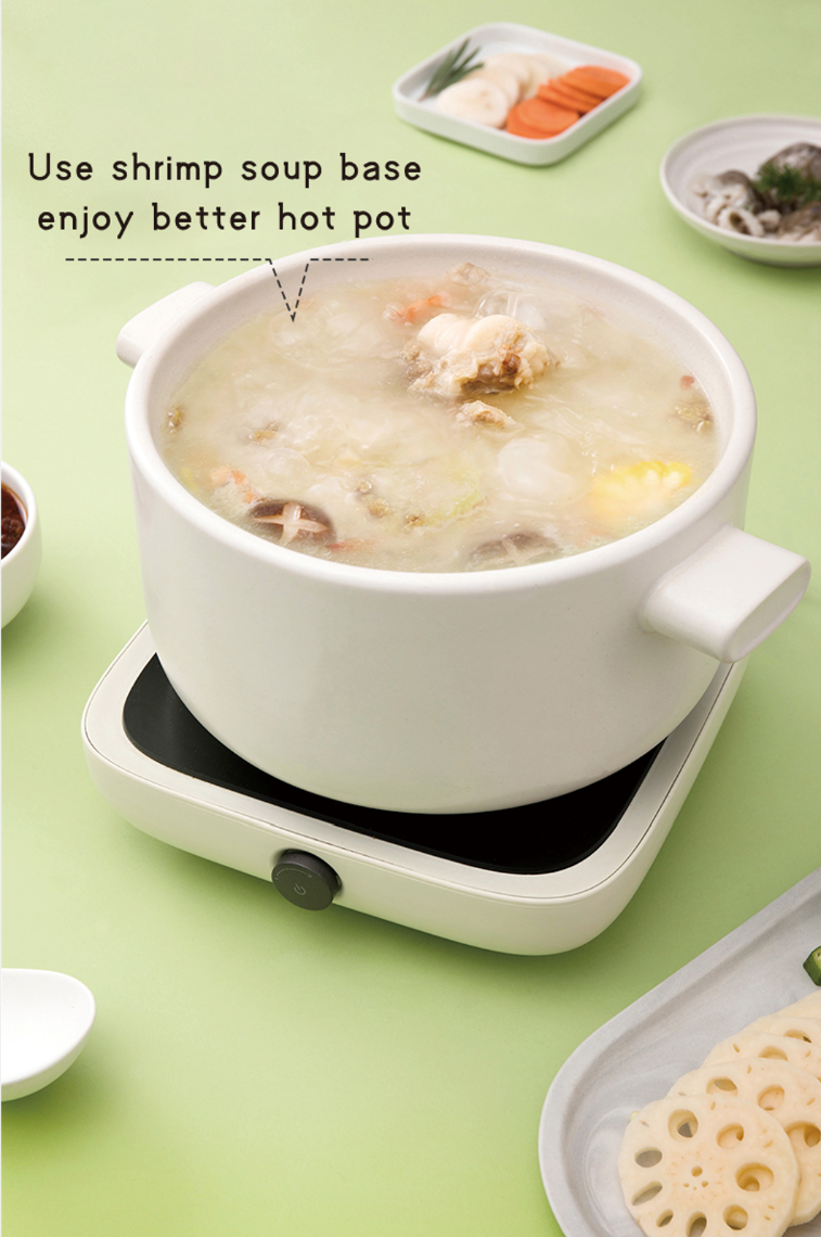 Bowl of HAIDILAO Shrimp Hot Pot Soup Base broth with shrimp and mushrooms simmering on a portable stove