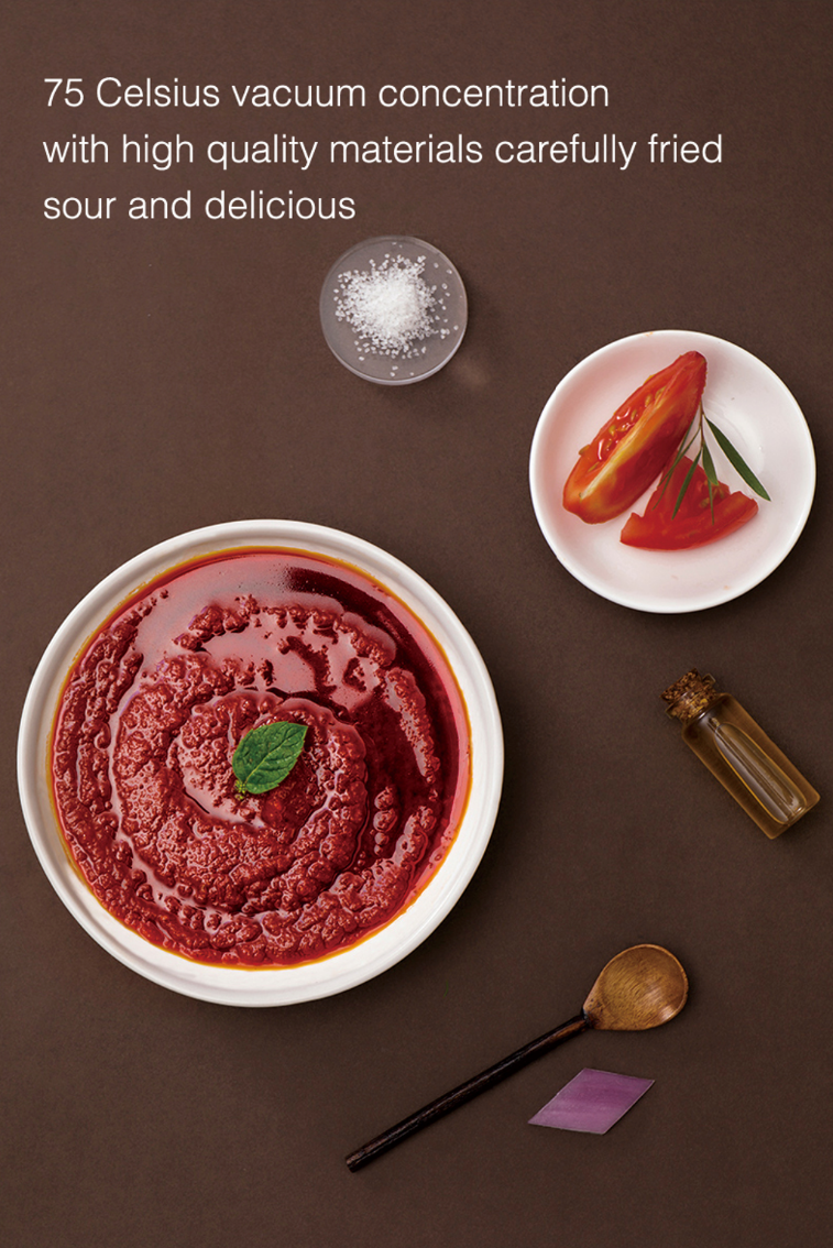 Bowl of HAIDILAO Tomato Hot Pot Soup Base sauce, vacuum concentrated at 75°C with fresh tomatoes